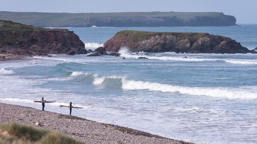 Surfers at Freshwater West near Gupton Farm Campsite, Pembrokeshire